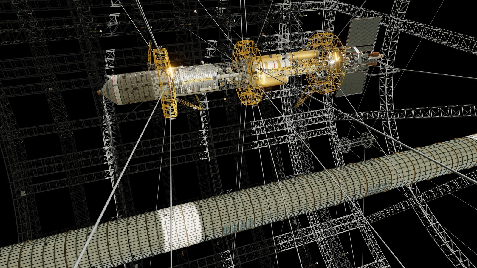 A long ship with a tapered nose sits in gold cradles among steel trusses, with a large tube in the foreground.