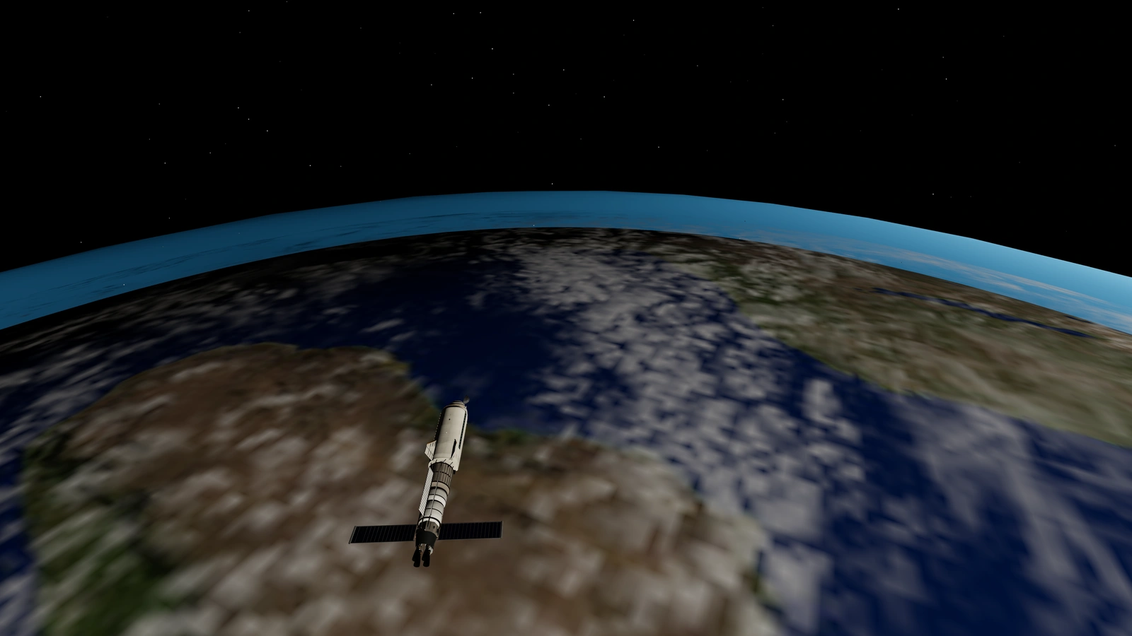 Earth filling the window as the stack falls toward a low perigee, with clouds and coastlines below.