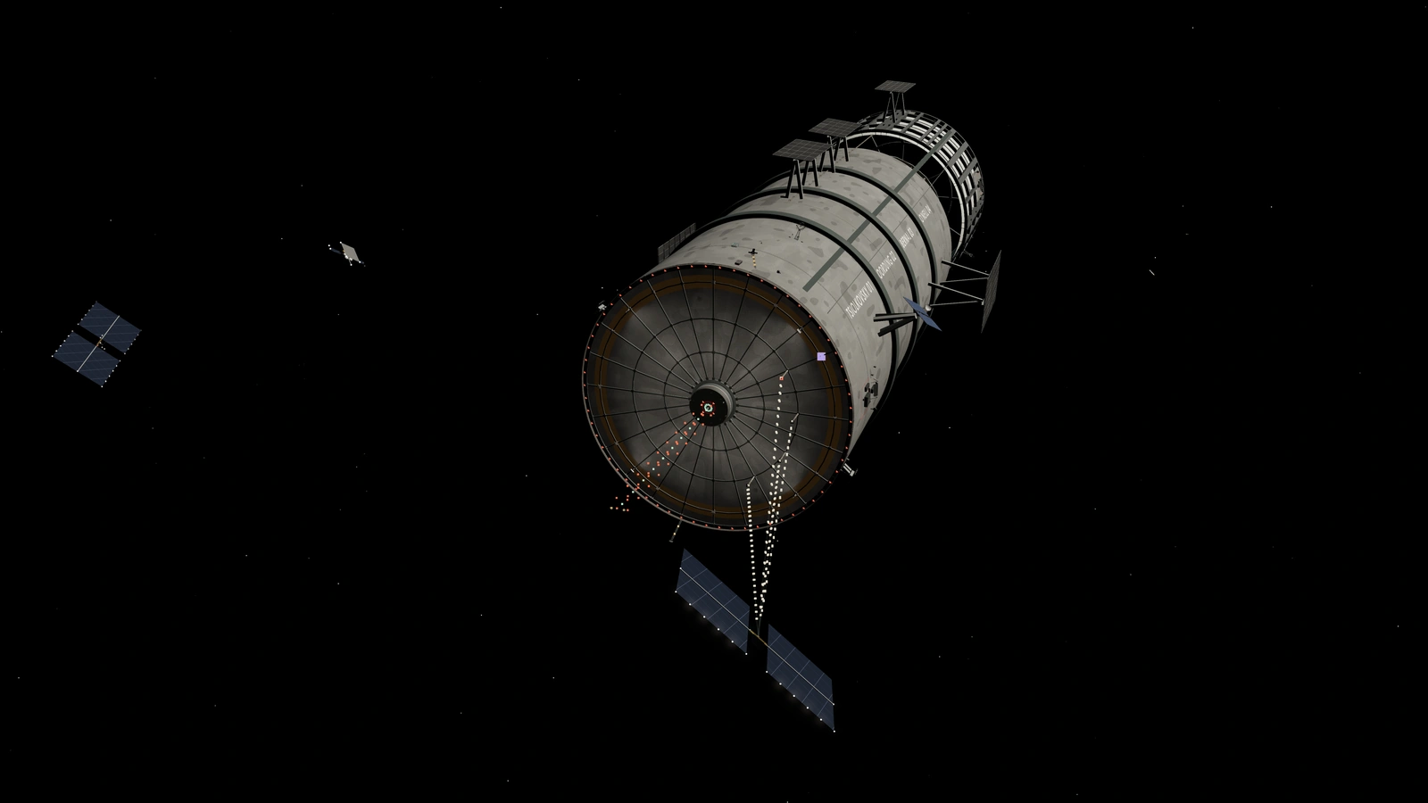 The aft face of the station from 25 km, with its ribbed shield, red rim lights, central tower and four landing masts.