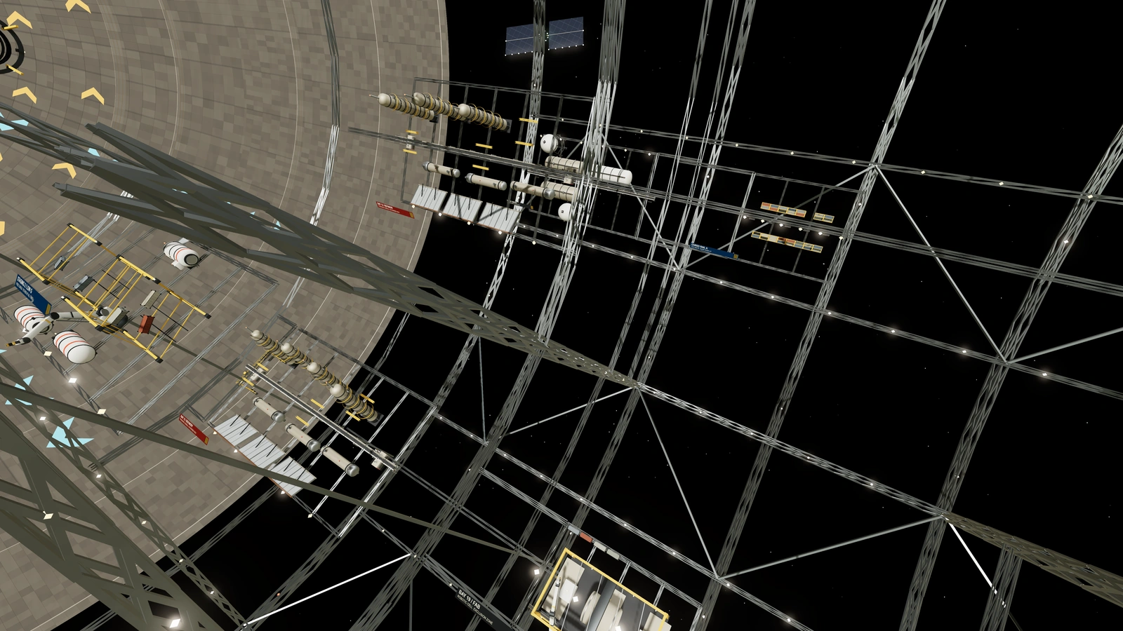 The open truss of the industrial rotor holds tank farms, cargo racks and gantries around a large empty volume.