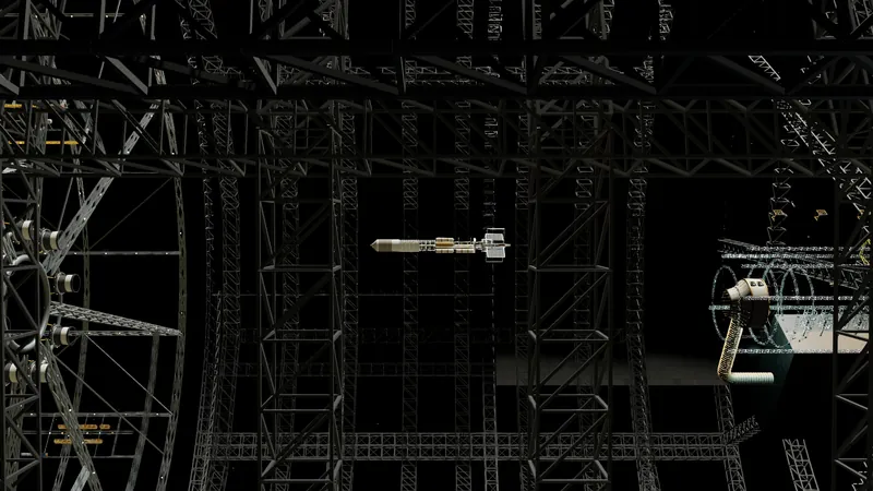 A view through a gridded cage of frames and ribs to a large spacecraft in a yard.